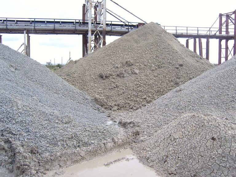 Piles of grey bentonite clay at a processing site