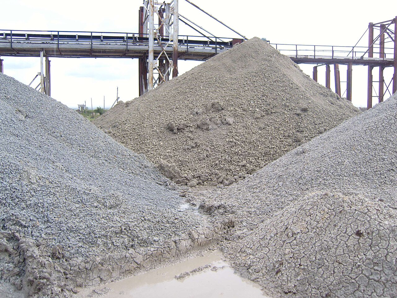 Piles of grey bentonite clay at a processing site