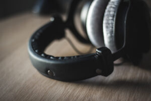 Over-ear studio headphones resting on a wooden table