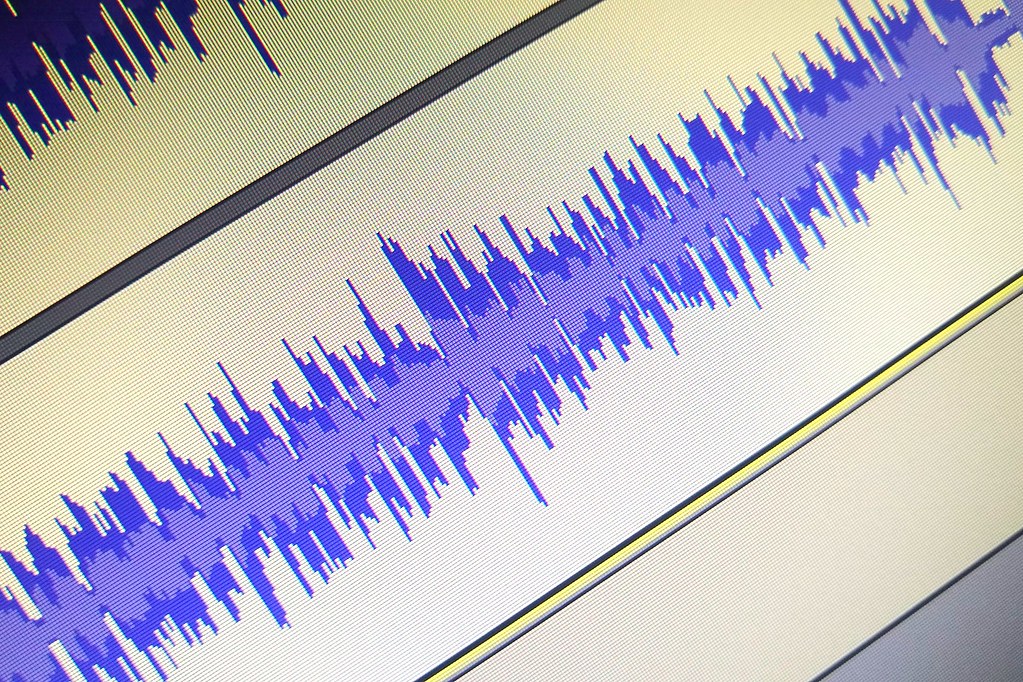 A blue audio waveform displayed on a screen
