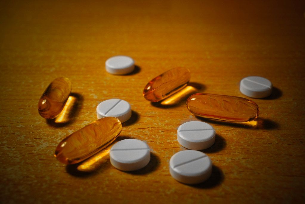 Assorted supplement capsules and tablets on a table