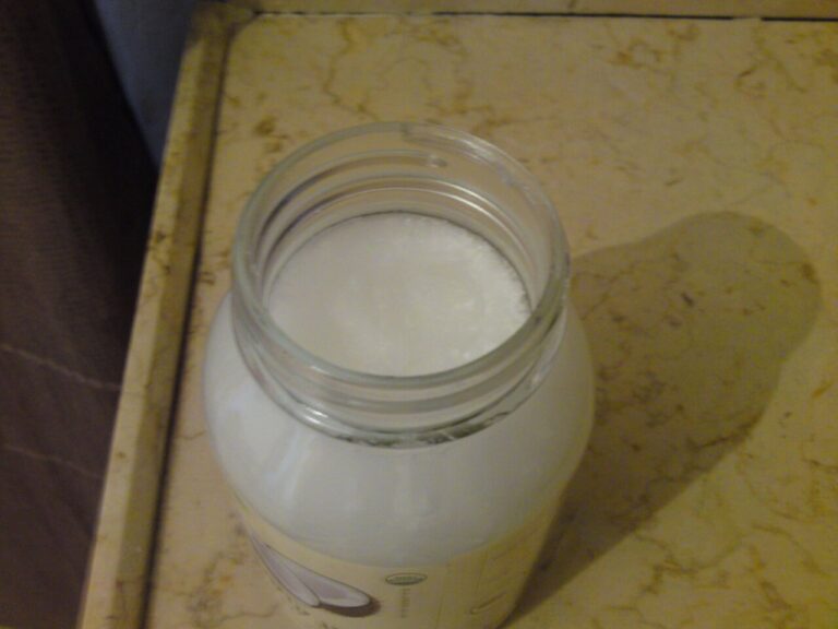 A glass jar of solid white coconut oil