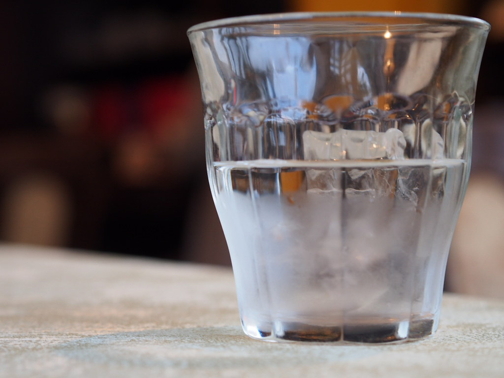 A clear glass of water on a table