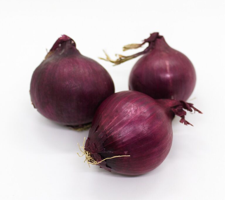 Three whole red onions, a common food source of quercetin