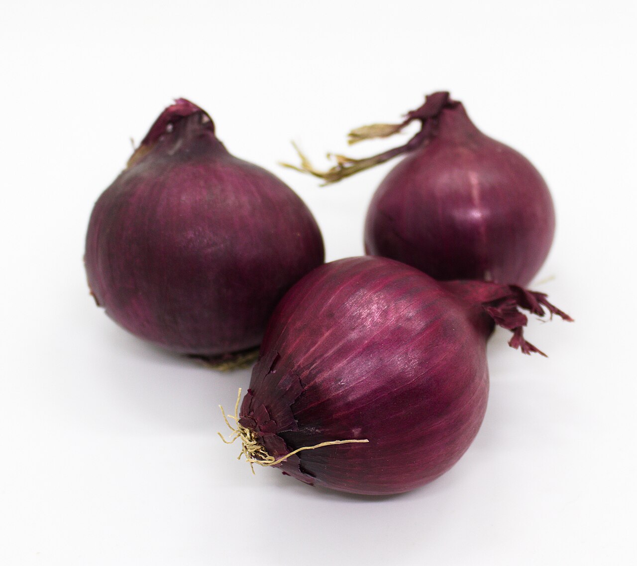 Three whole red onions, a common food source of quercetin