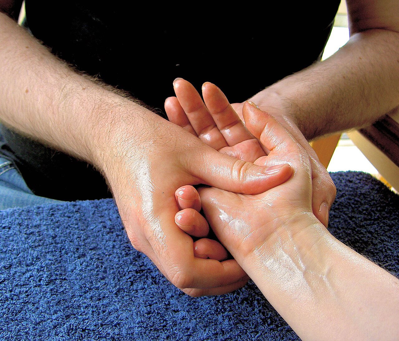 Hands giving a gentle hand and arm massage