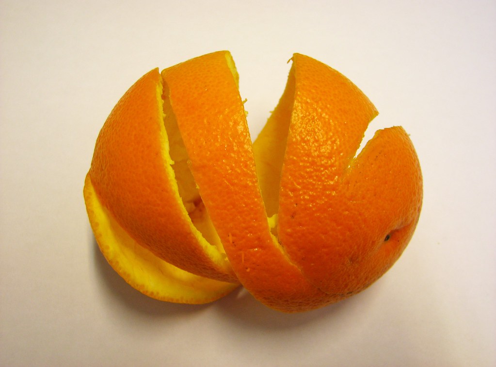 An orange with its peel cut into a spiral