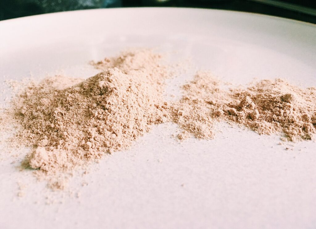 Fine psyllium husk powder on a light surface
