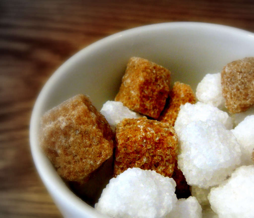 A bowl of white and brown sugar cubes